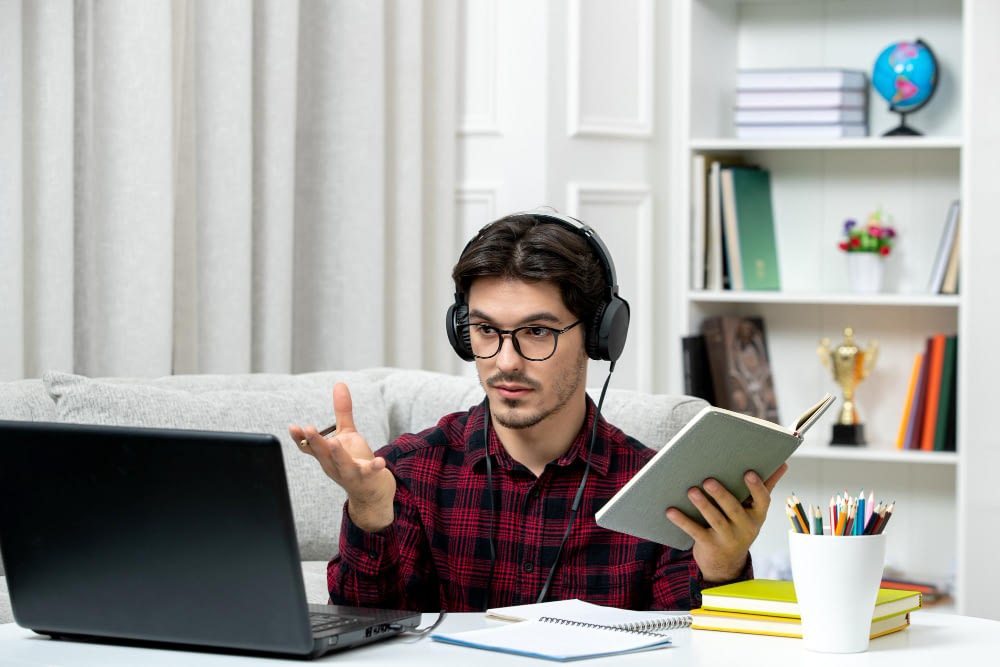 student online cute guy checked shirt with glasses studying computer waving hands